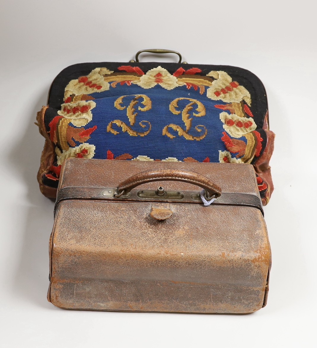 A 19th century needlework and leather bag and a leather Gladstone bag, needlework bag frame 40cms wide